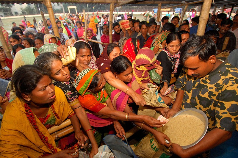 Women struggle to get rice at a government run fair price shop in Dhaka as Bangladesh faces a severe food shortage, in 2008.